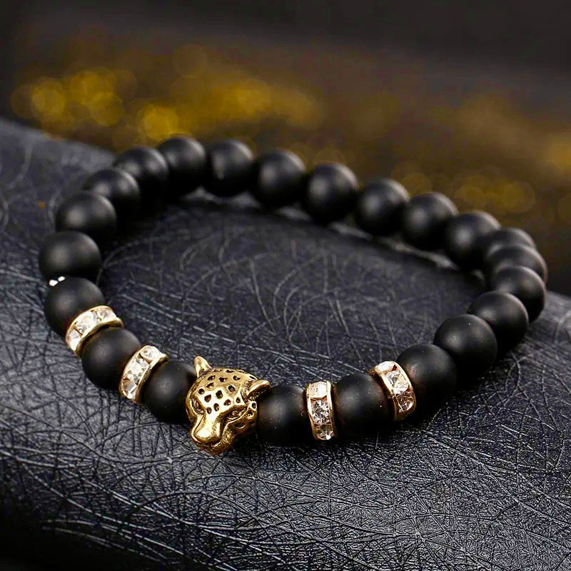 "Wild Elegance: Matte Black Onyx Bead Bracelet with Gold Accents, Rhinestone Rings, and Leopard Centerpiece"