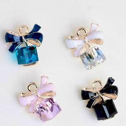 "Present Charm - Elegant Gift-Inspired Keychain Accessory with Glass Bottom and Delicate Ribbon"